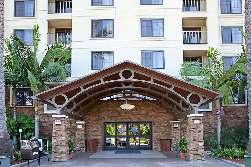 Arrive to a welcoming porte-cochère and palm-lined entrance.