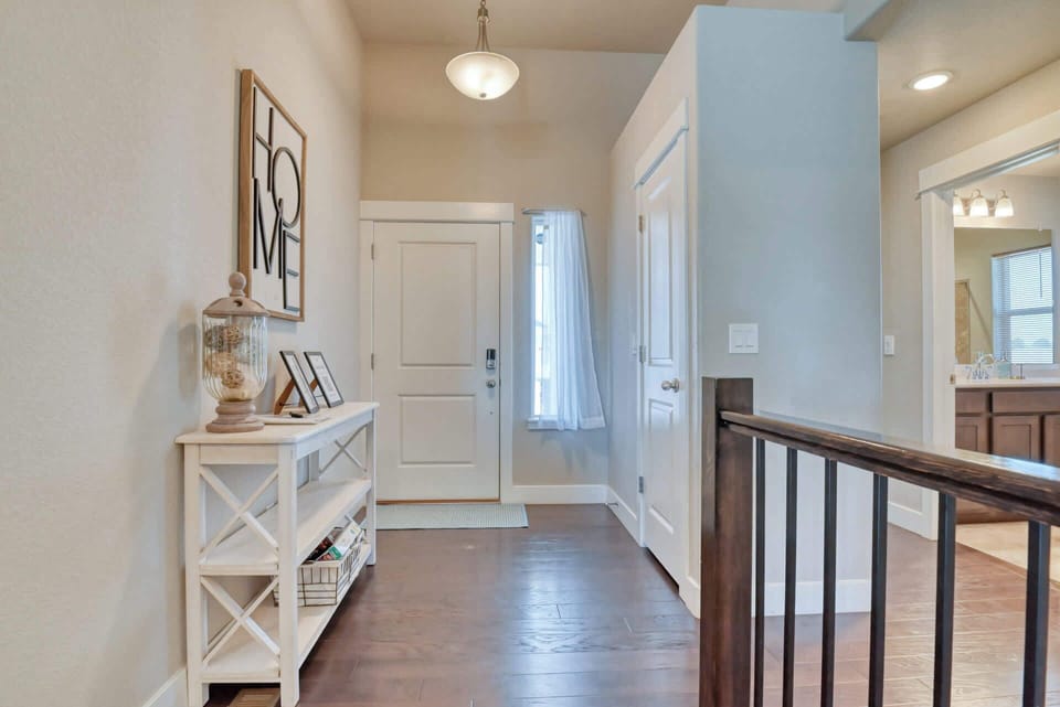 Chic hallway with high ceilings and warm lighting. Very Demure. 