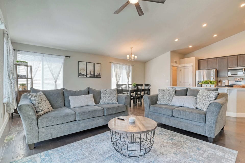 The property features a stylish and cozy living room, designed for relaxation and social gathering. The plush sofas and modern decor create a warm and inviting atmosphere, perfect for movie nights, game nights, or unwinding after a long day.