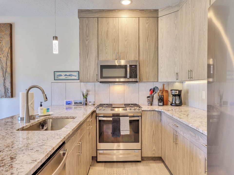 View of Kitchen with Modern Cabinetry, Upgraded Lighting and Appliances