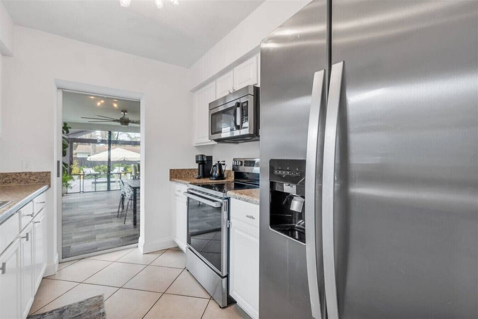 Kitchen Delight: Modern appliances and a view of the outdoor paradise await your culinary adventures!