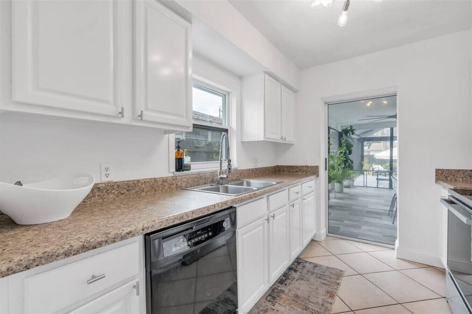 Gourmet Kitchen: Whip up meals with modern appliances and a view of the inviting outdoor patio!