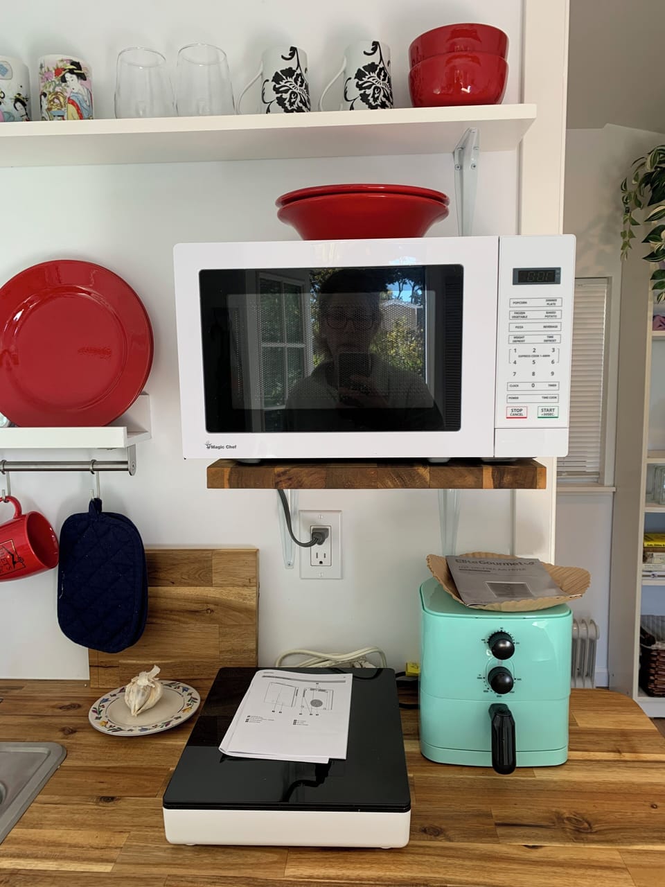 Microwave, IKEA induction cooktop, new air fryer with parchment paper liners.