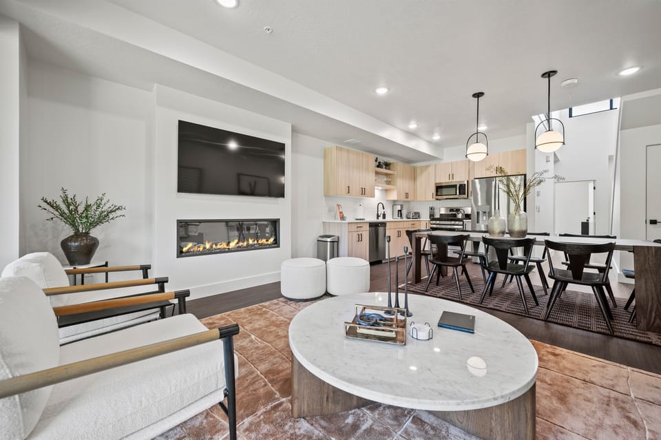The open-concept living space, complete with a dining area, facilitates effortless conversation with family and friends.