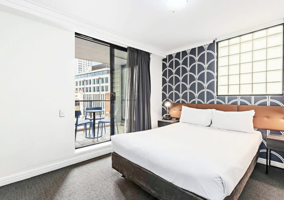 A bright bedroom featuring a bed