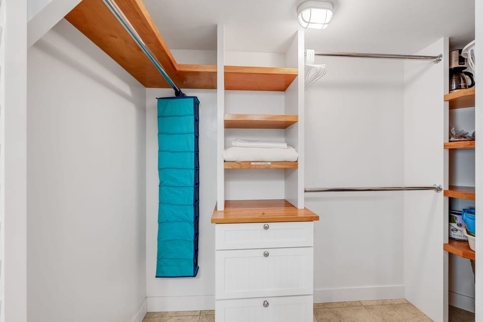 The walk-in closet provides ample space for luggages and clothes