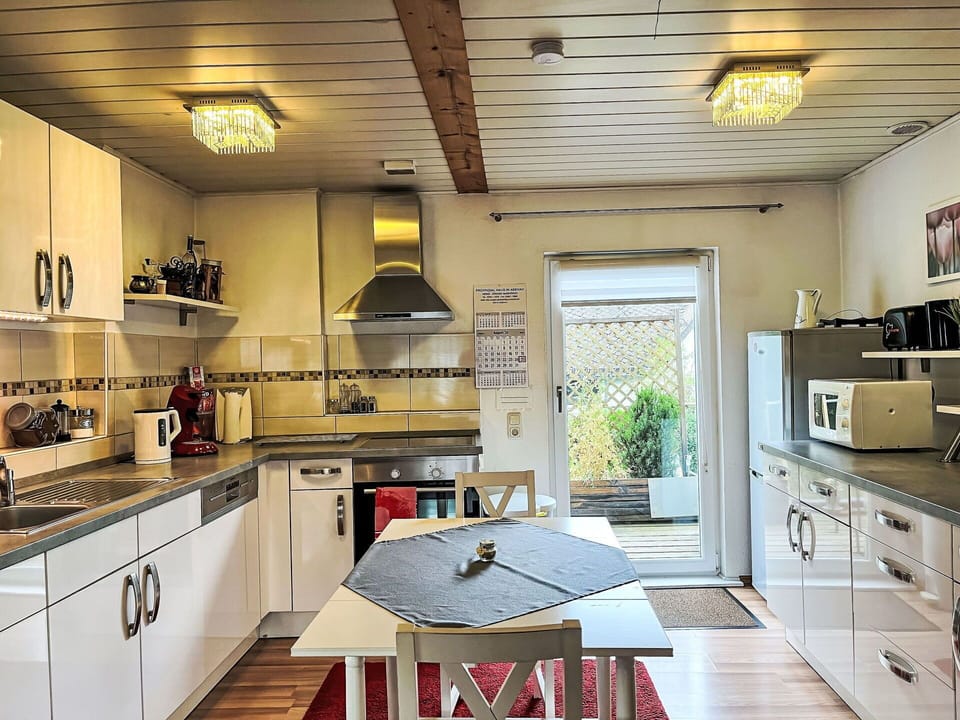 Cabinetry, Countertop, Property, Kitchen, Wood, Kitchen Stove, Lighting, Exhaust Hood, Drawer, Kitchen Appliance
