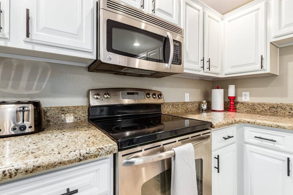 Large fully stocked kitchen with stainless steel appliances.