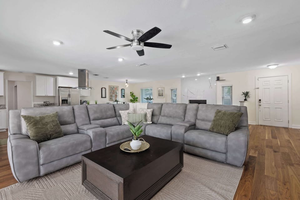This open-concept living area offers cozy seating, modern kitchen views, and a stylish, welcoming atmosphere perfect for relaxation or entertaining guests.