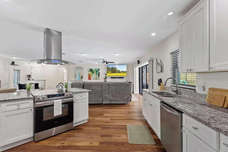 Enjoy cooking in this modern kitchen with stainless steel appliances, granite countertops, and open access to the spacious living area for effortless entertaining.