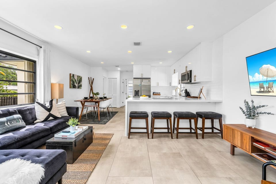 Open concept floorplan with minimalist furnishings, inspired artwork, and lush plants create a calming ambiance, making it an ideal space to reconnect, retreat, and reset.