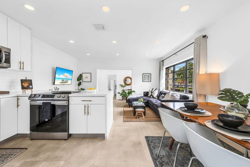 Open floorplan features a living room, dining for 6, smart streaming 65" TV, and access to the kitchen.