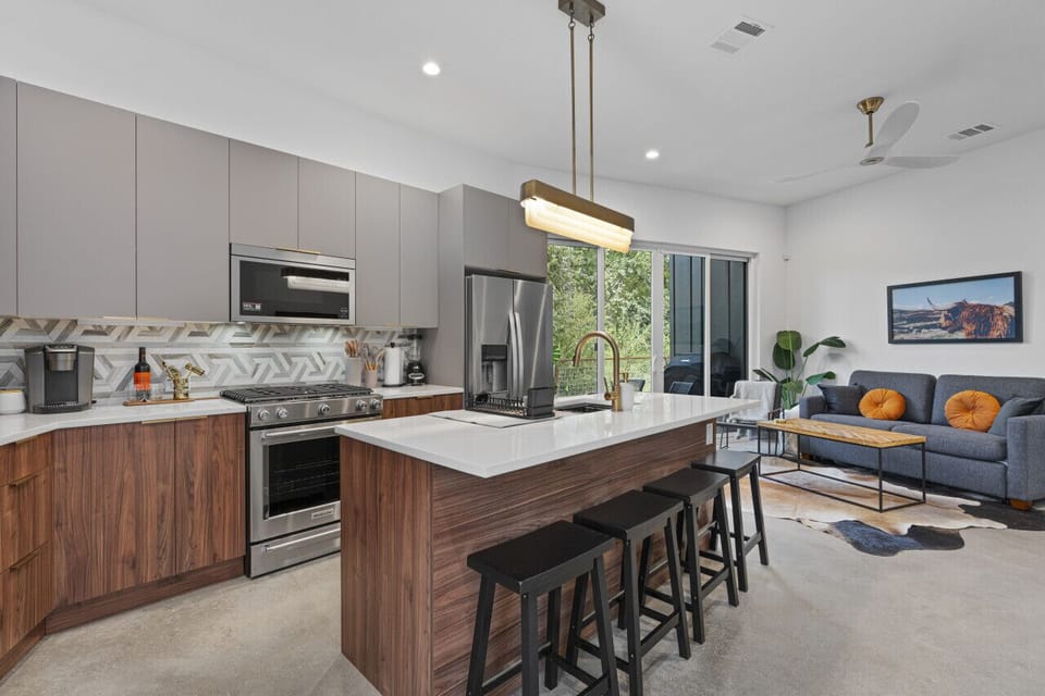 Spacious kitchen with a modern island and sleek appliances perfect for cooking and gathering.