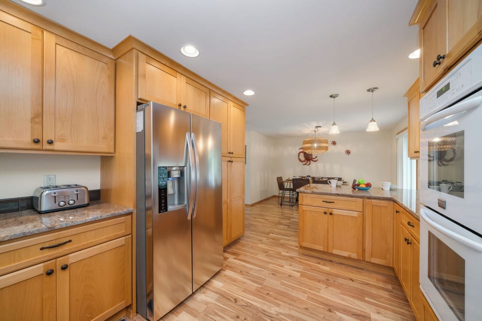Gourmet kitchen with double oven breakfast bar and open to the dining room.
