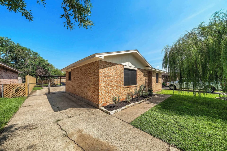Charming Exterior: Discover a beautiful brick home nestled in a vibrant, leafy neighborhood,