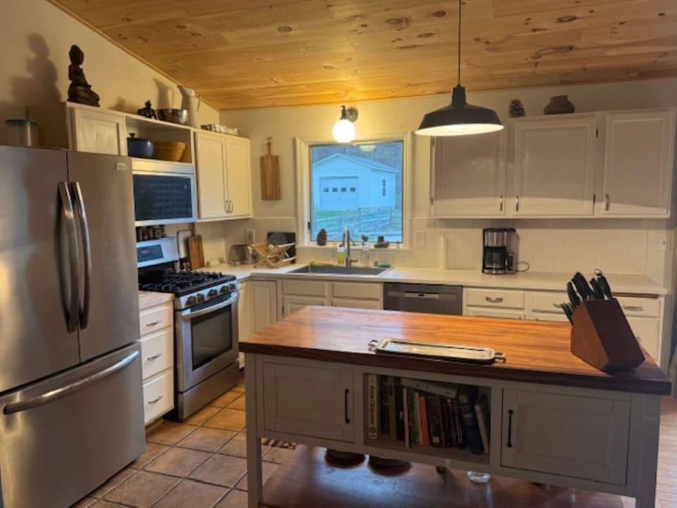 Kitchen w large island & Picture window overlooking yard and pool 