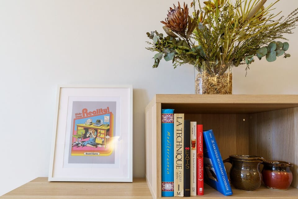 The room features stylish art and a curated selection of books, adding character and inspiration to the cosy space.