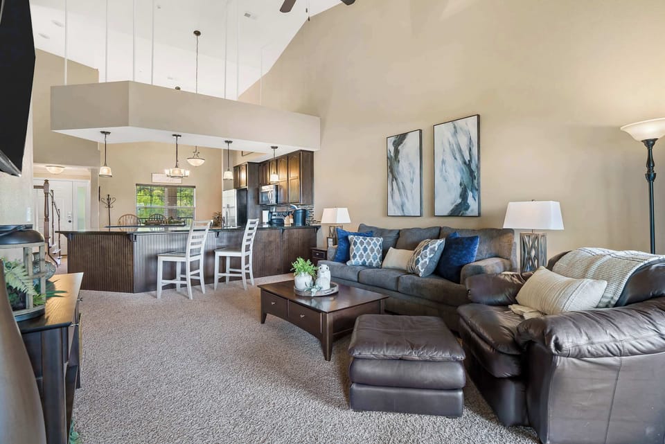 Living room with balcony access, sofa sleeper, and Smart TV