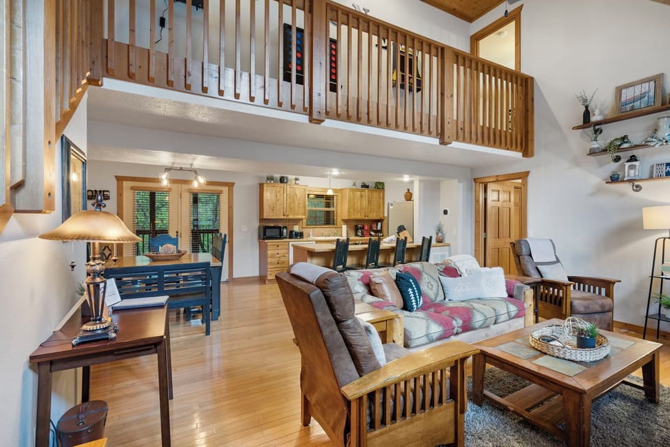 Soaring ceilings allow tons of natural light into the open Kitchen/Dining/Living areas with Smart TV and Gas Fireplace