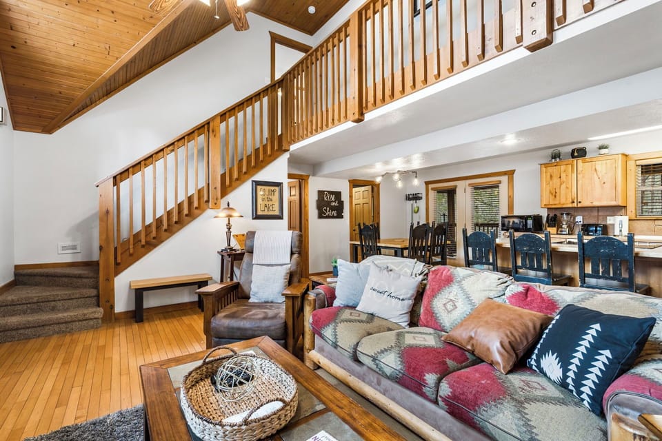 Soaring ceilings allow tons of natural light into the open Kitchen/Dining/Living areas with Smart TV and Gas Fireplace