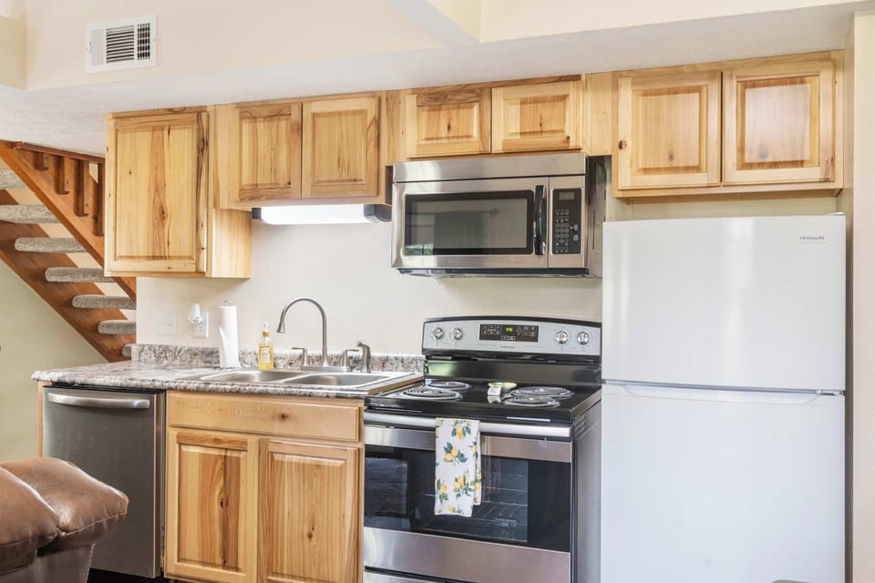 The bright kitchen offers ample space & all the comforts of home