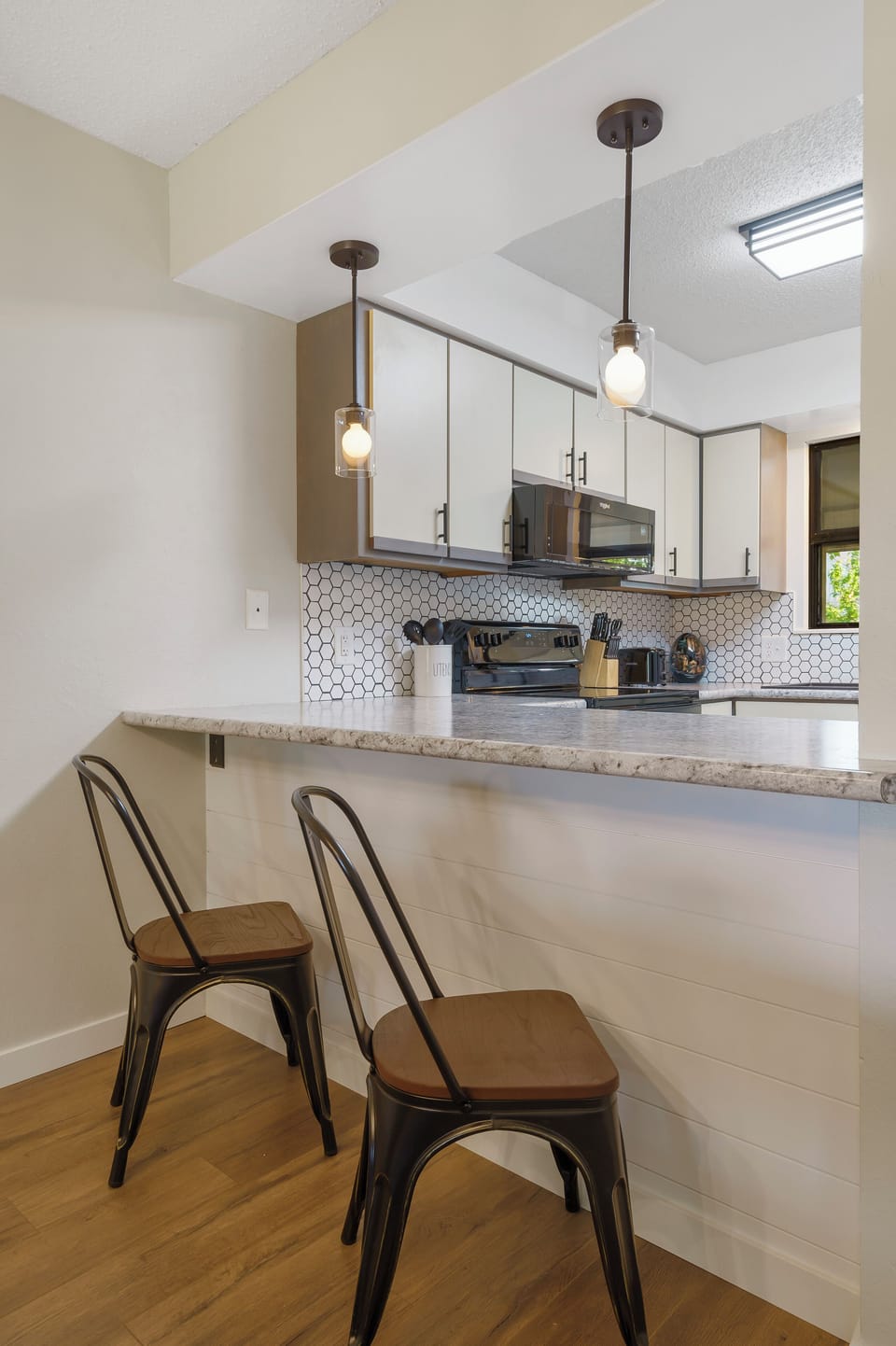 Bar seating along the kitchen