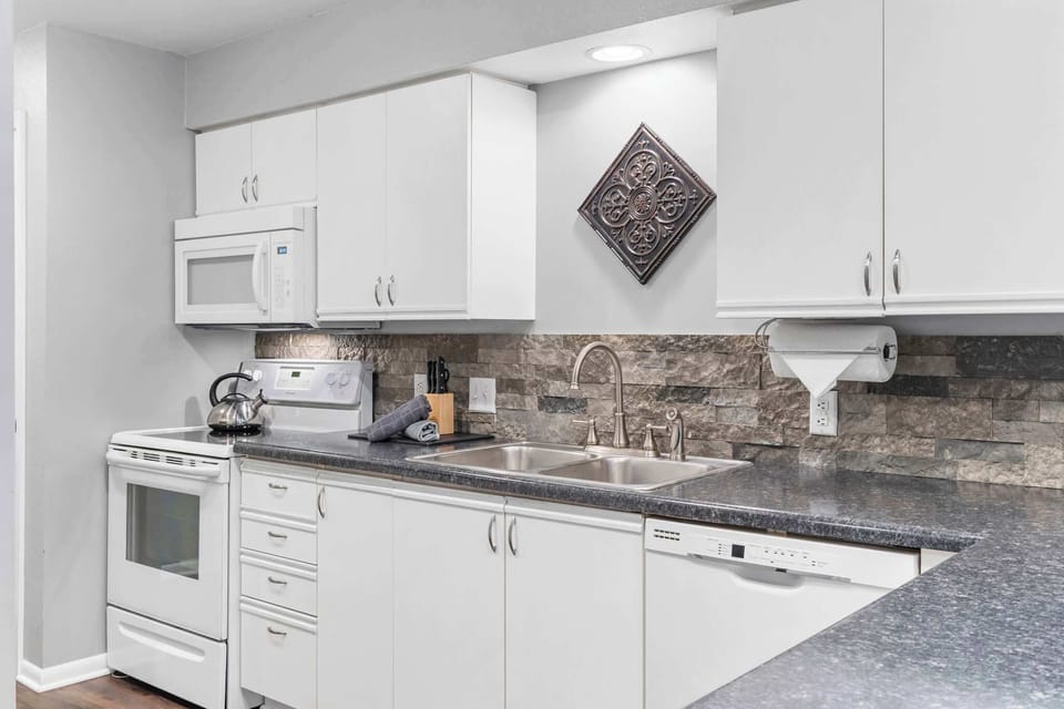 The airy, open kitchen is fully equipped with all the comforts of home