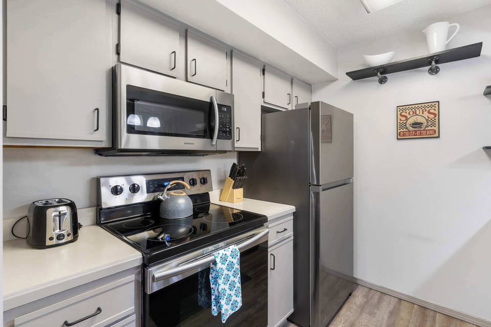 Kitchen features coffee pot, tea kettle and more!