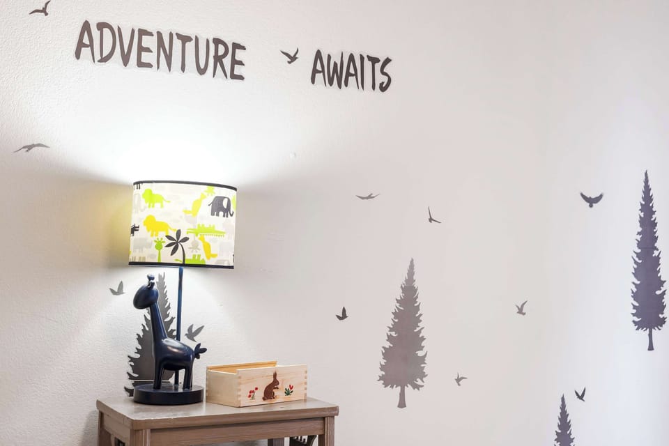 Kids will adore this camp-style bedroom with twin-over-full bunk beds & Smart TV