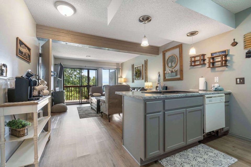 Open living space with Queen sofa sleeper, TV, and deck access