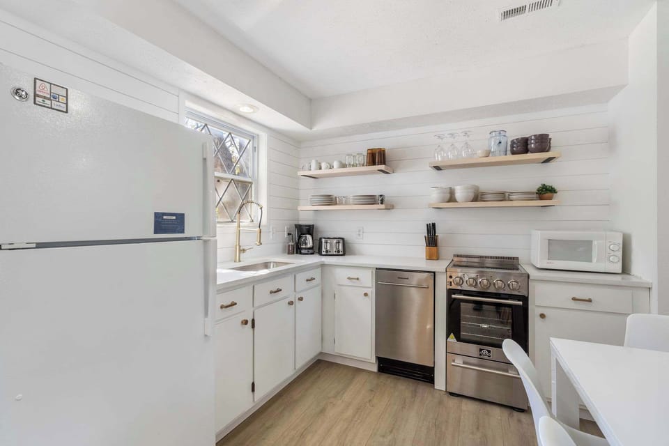 The bright, airy kitchen offers ample space & all the comforts of home