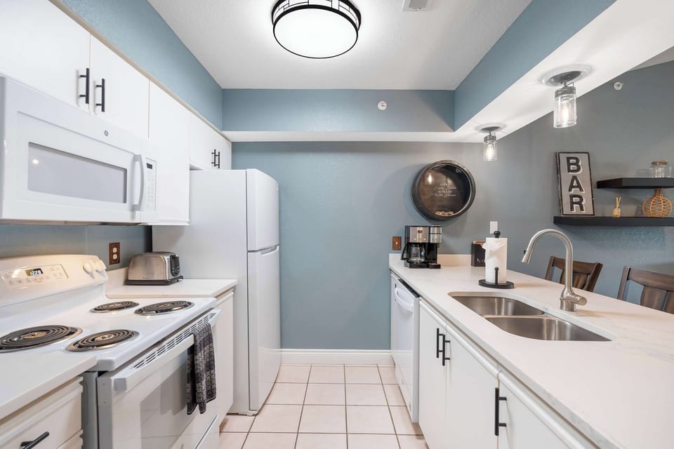 The open, breezy kitchen offers ample space & every home comfort