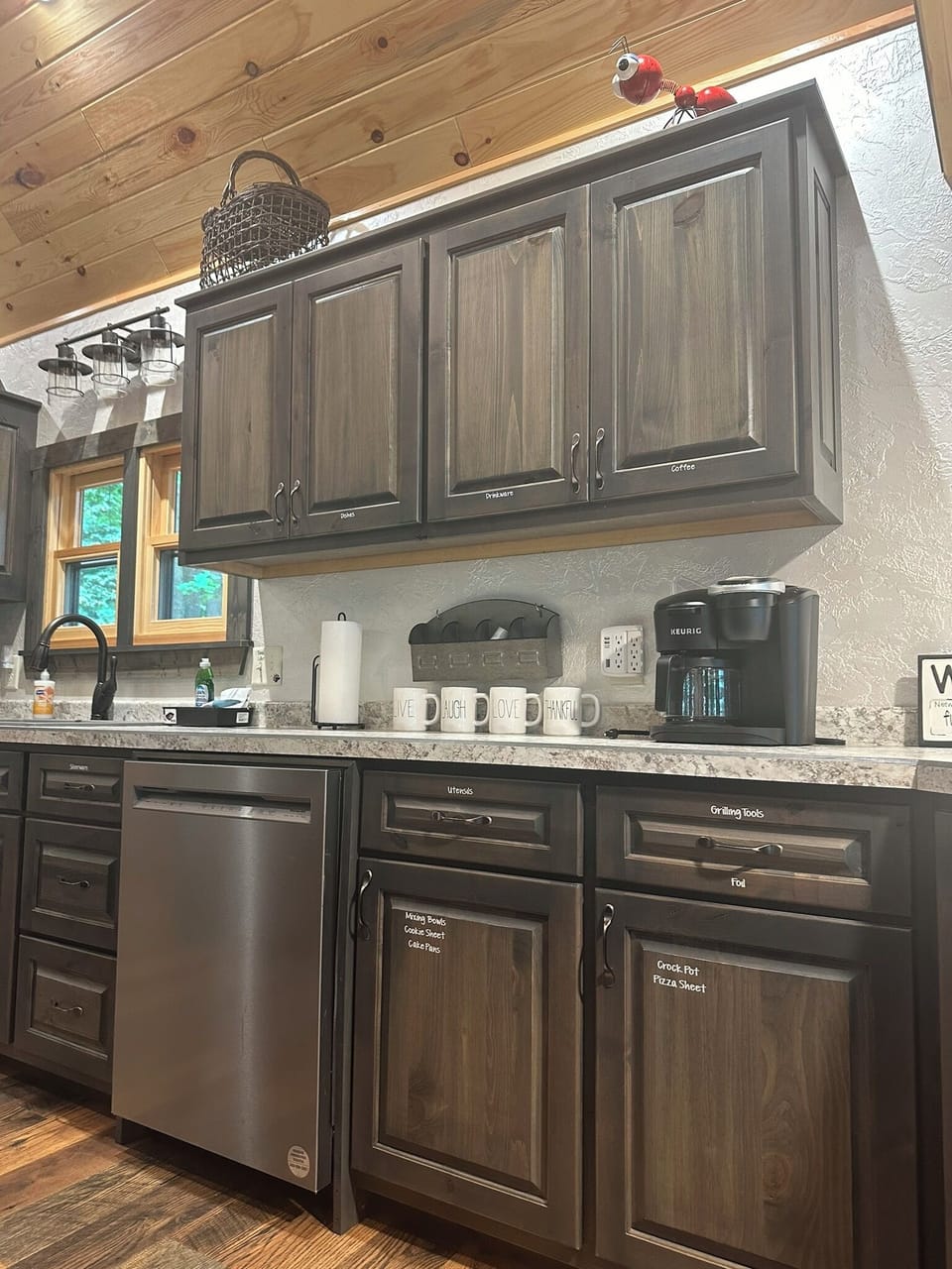 Kitchen has a dishwasher, microwave, range, refrigerator, and even a pizza oven.