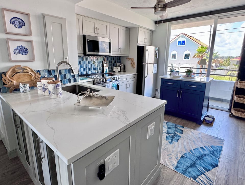 New custom kitchen is spacious and bright. Coastal decor you will love.