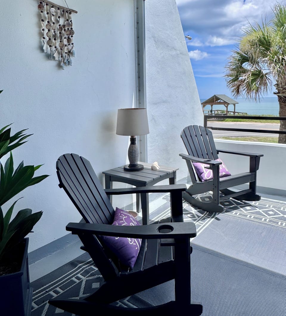 Relax on the rockers. Watch the dolphins swim and the parade of pelicans fly by.