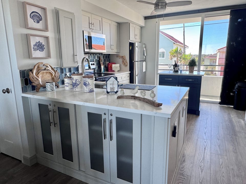 New custom kitchen is spacious and bright. Coastal decor you will love.