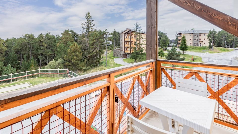 Private balcony with seating, offering lovely views of the surrounding greenery and a tranquil escape outdoors.