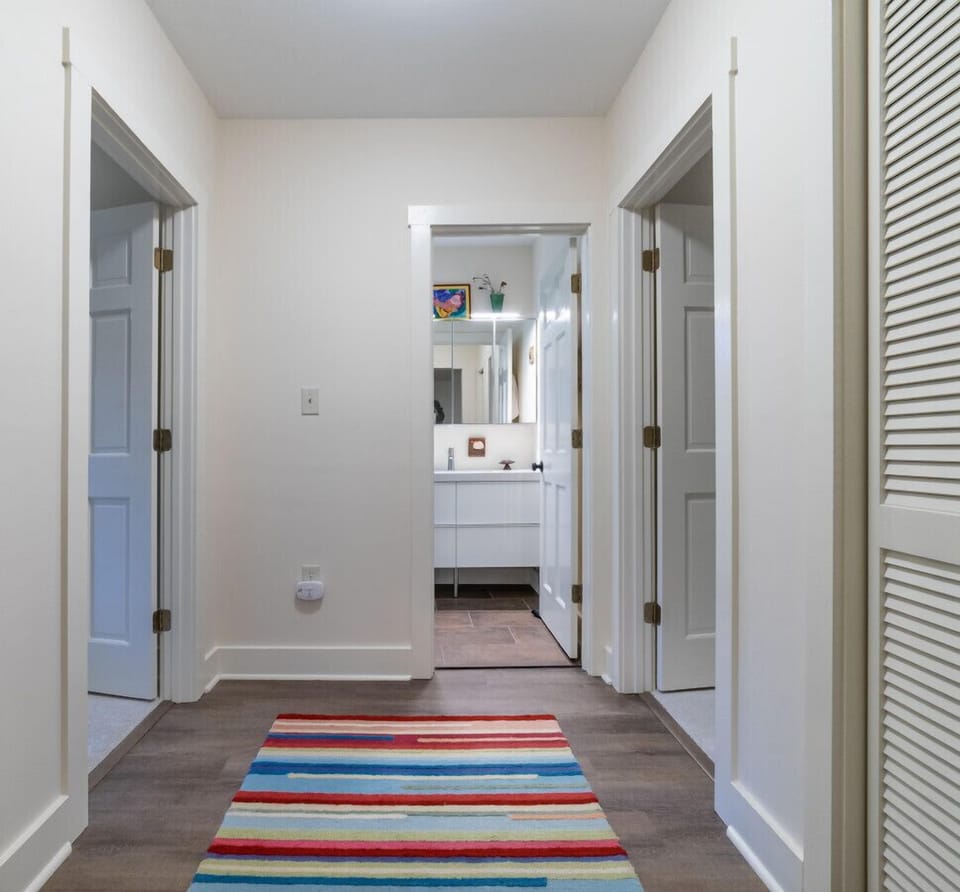 Hallway leading to the shared bathroom on the lower level.