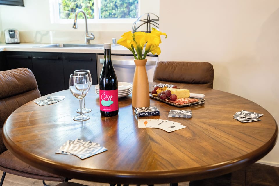 Modern dining nook set within an open-concept living space, featuring a round table for easy gatherings, stylish décor, and seamless flow into the cozy lounge area.
