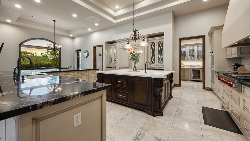 Luxurious kitchen with dual islands, high-end appliances, and elegant details.