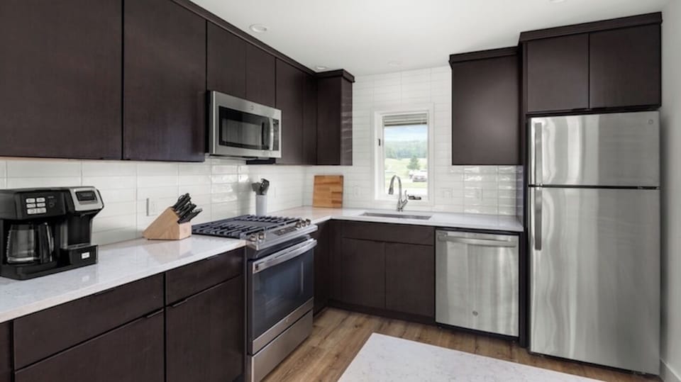 Remodeled kitchen with stainless appliances.