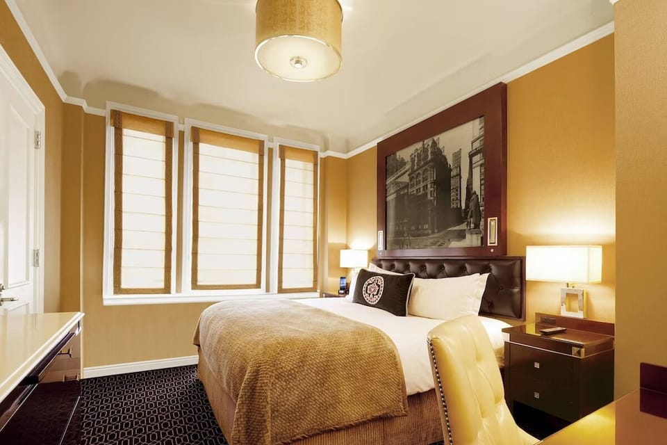 Unwind in a sunlit bedroom with crisp, cozy bedding.
