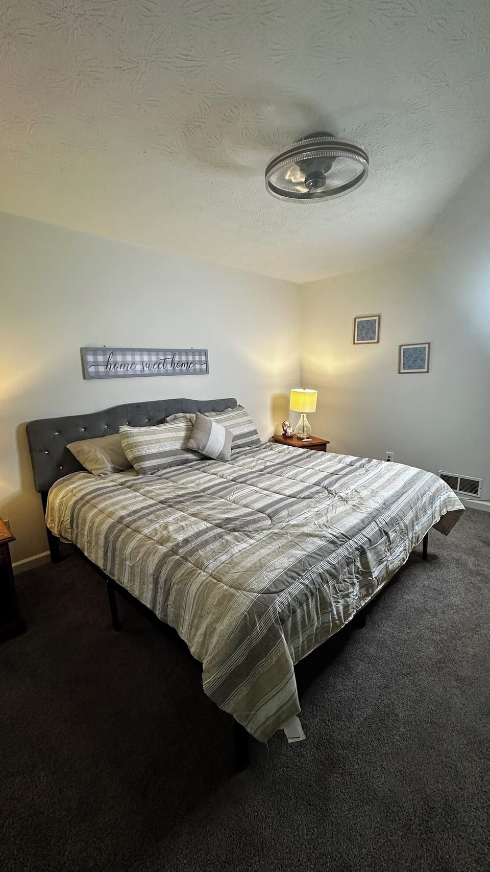 Primary suite: walk-in closet, 70in TV, tub/shower, dual sinks, wooded view