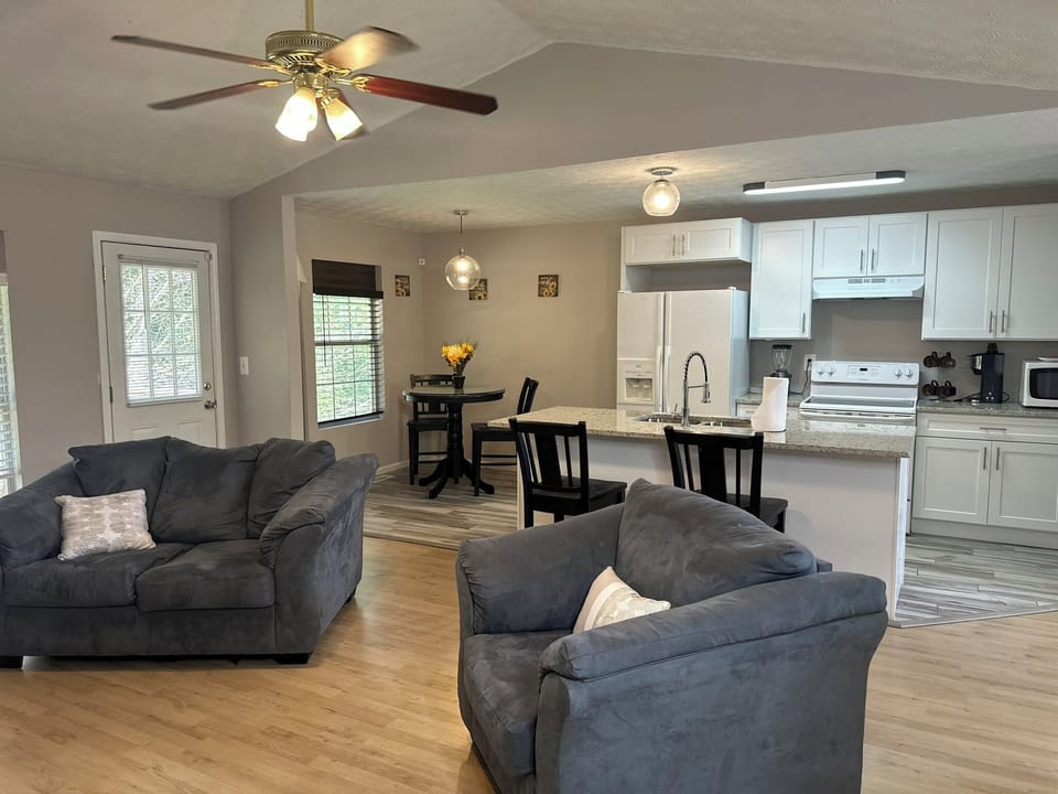 Bright, airy living room with 70 70-inch TV and a fireplace