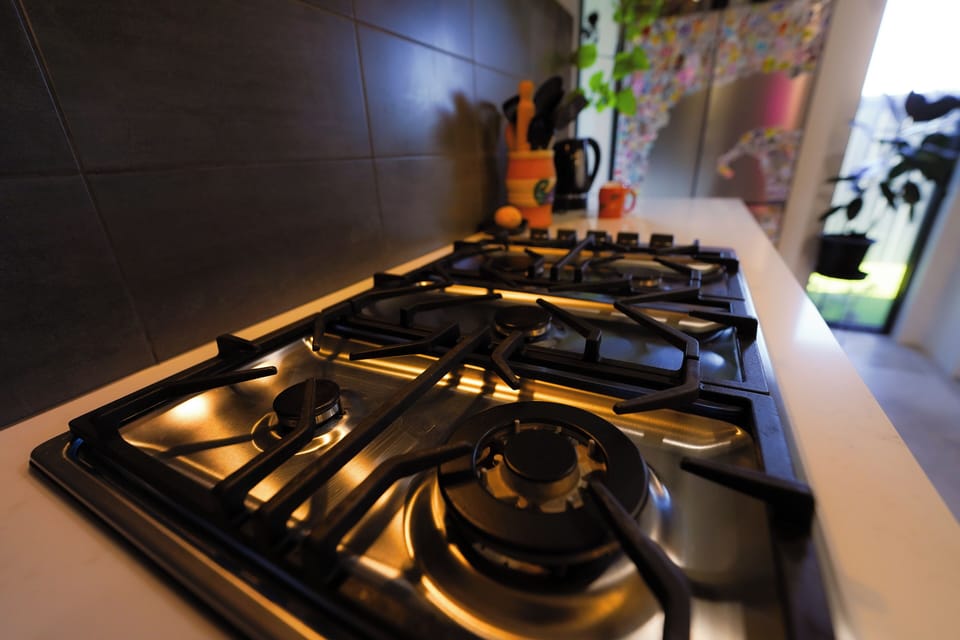 Clean, bright kitchen space with appliances, cookware and tea/coffee available