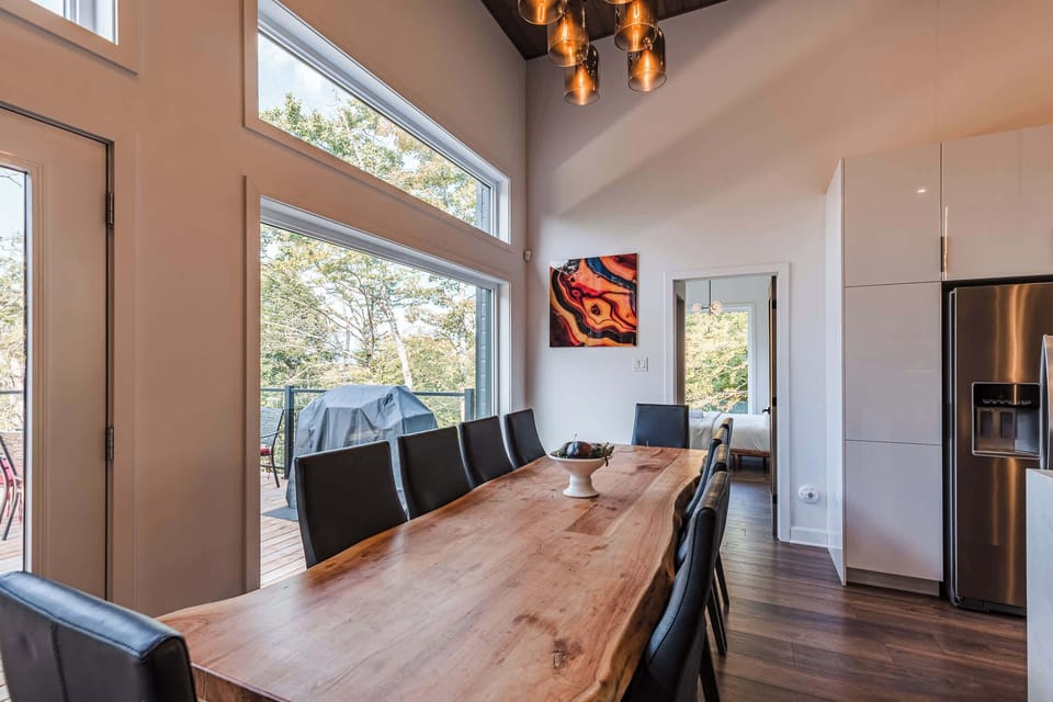 Dining table detail shot with centerpiece and full-height windows