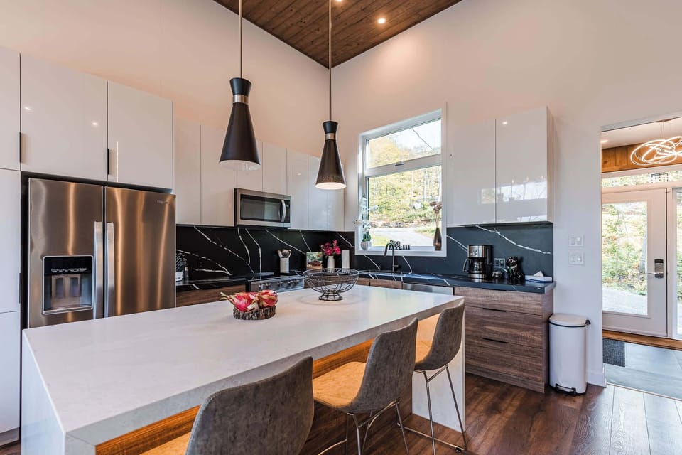 Kitchen island and prep area under pendant lighting and big windows