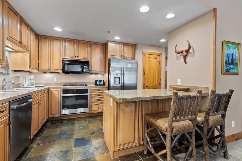 Step into your fully equipped mountain kitchen, where rustic charm meets modern convenience. Create memorable meals in this spacious space.