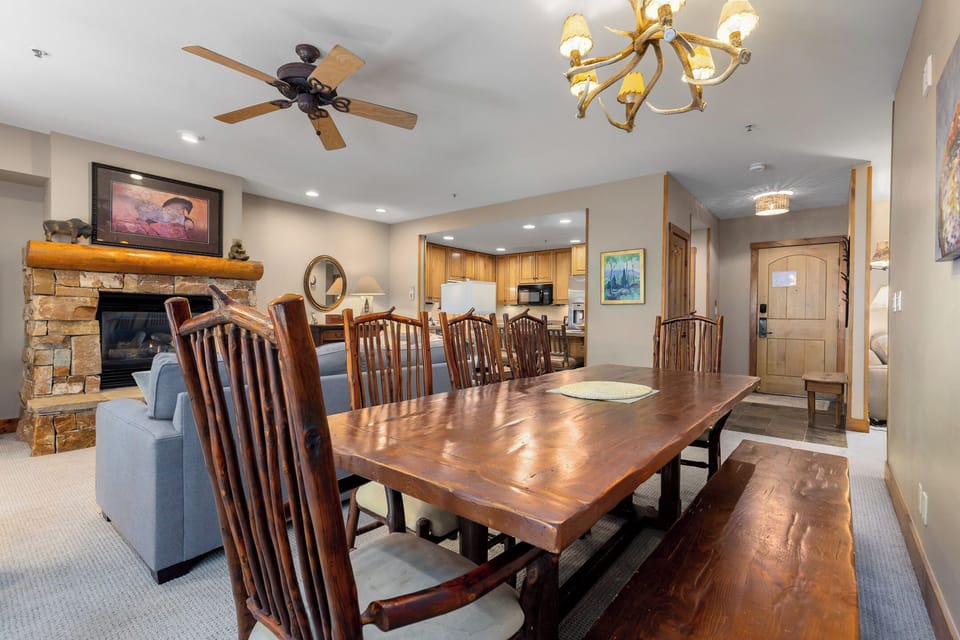Gather around your handsome dining table for memorable meals, warmed by the cozy stone fireplace nearby.
