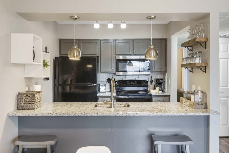 The sleek, modern kitchen offer ample space & all the comforts of home 